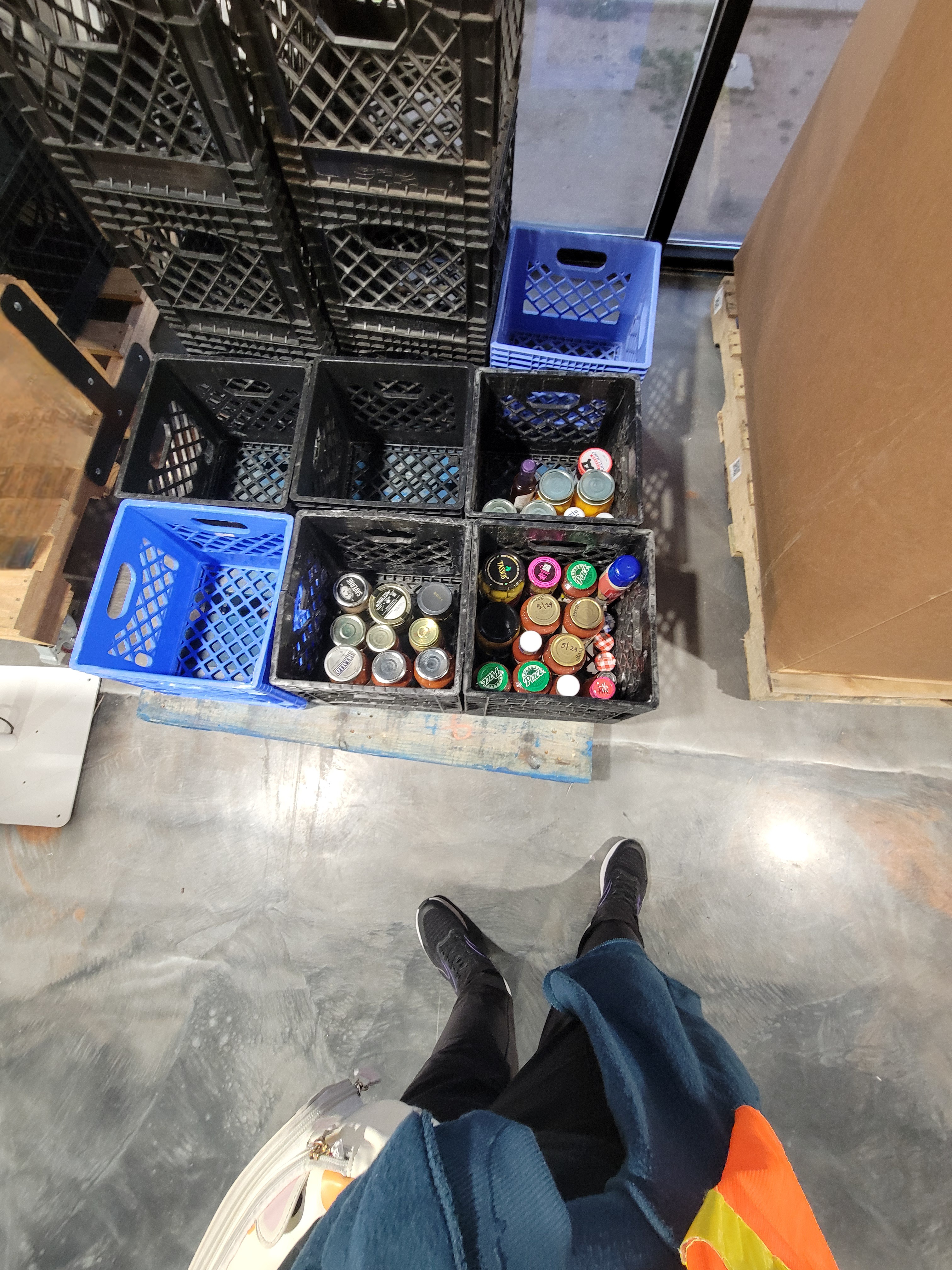 Crates filled with some glass jars.